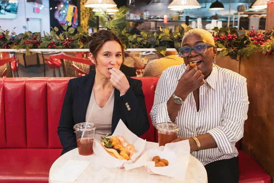 two women sitting enjoying soul food